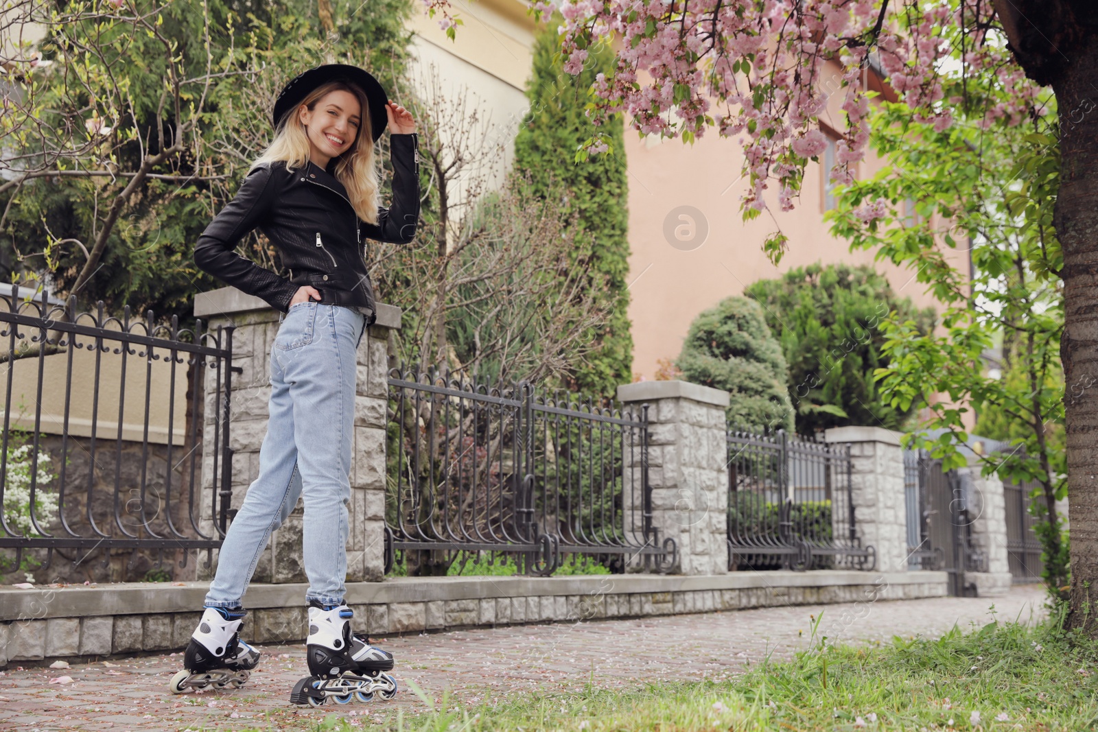 Photo of Young woman roller skating on spring day