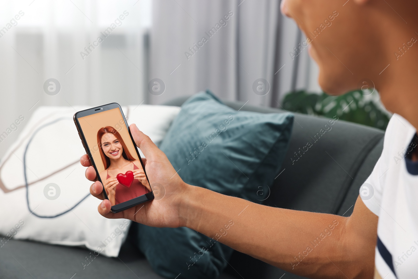 Image of Long distance love. Man having video chat with his girlfriend via smartphone at home, closeup