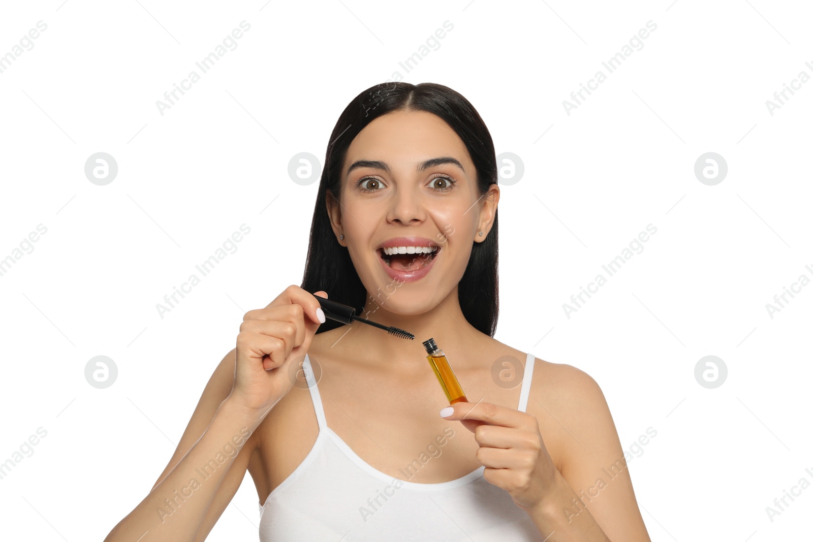 Photo of Excited woman with eyelash oil on white background