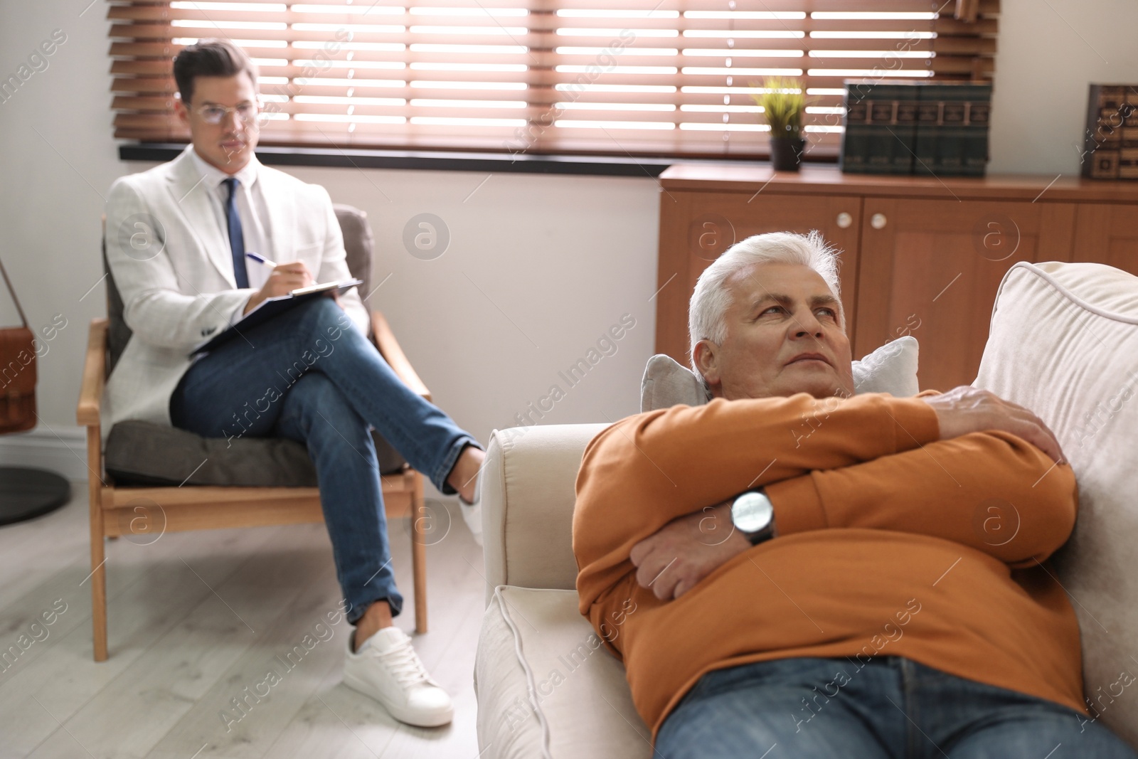 Photo of Professional psychotherapist working with patient in office