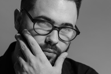 Photo of Portrait of handsome bearded man on grey background. Black and white effect