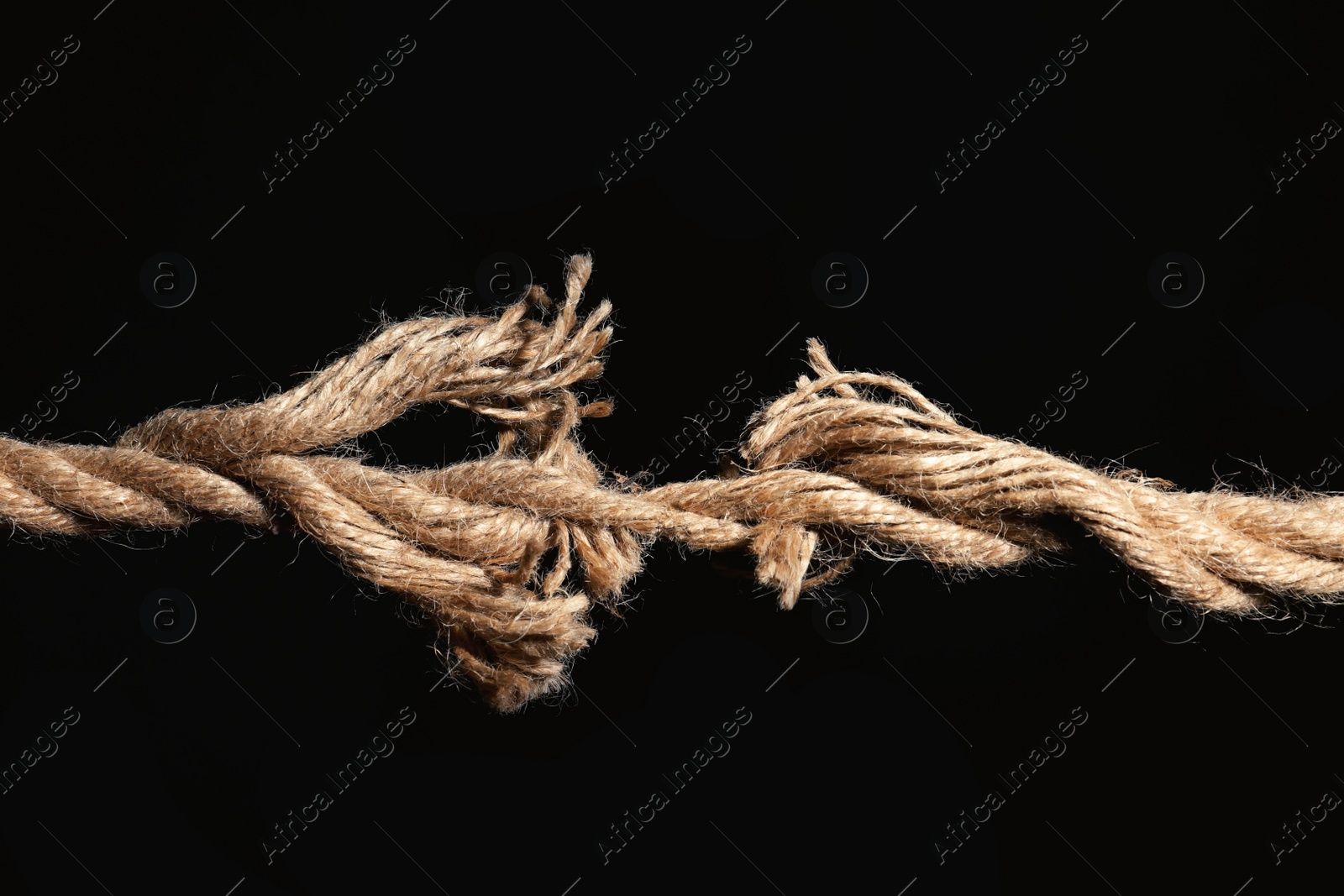 Photo of Rupture of cotton rope on black background