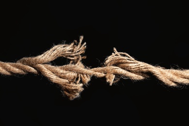 Rupture of cotton rope on black background