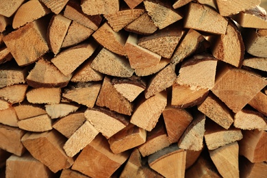 Photo of Stack of cut firewood as background, closeup