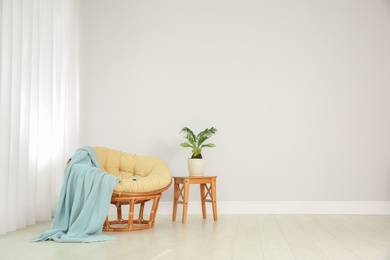 Living room interior with round lounge chair near wall