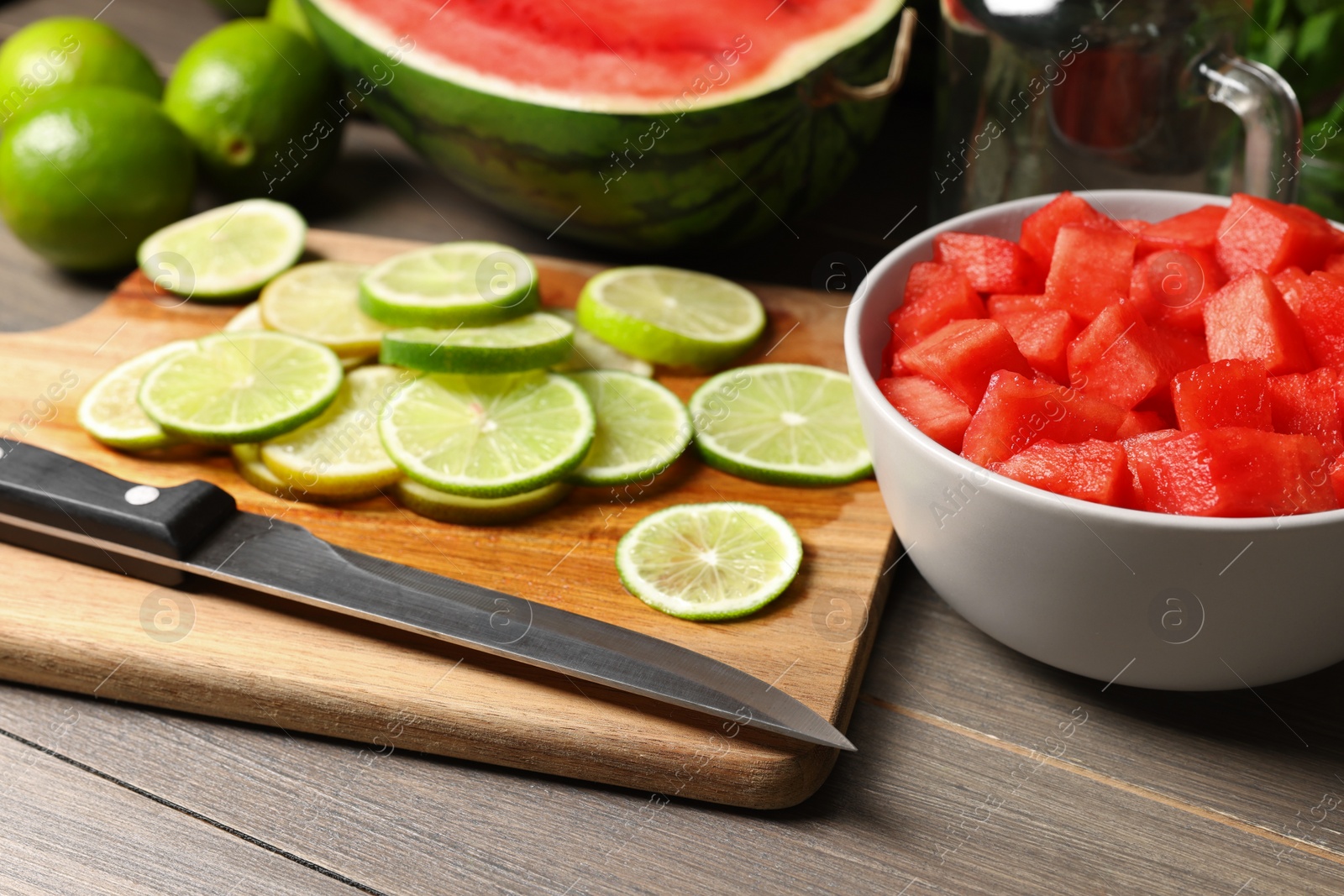 Photo of Fresh ingredients for making watermelon drink with lime on wooden table