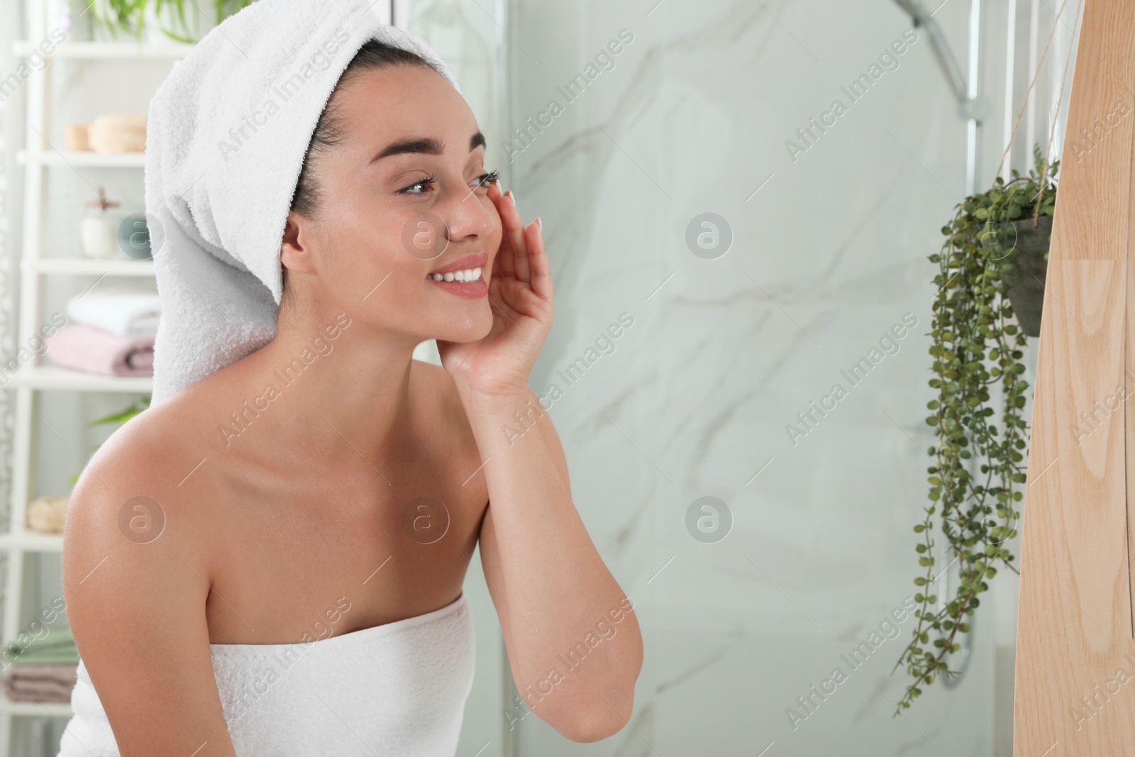 Photo of Beautiful young woman with perfect skin in bathroom, space for text. Facial wash