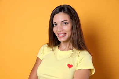 Photo of Portrait of beautiful woman on yellow background