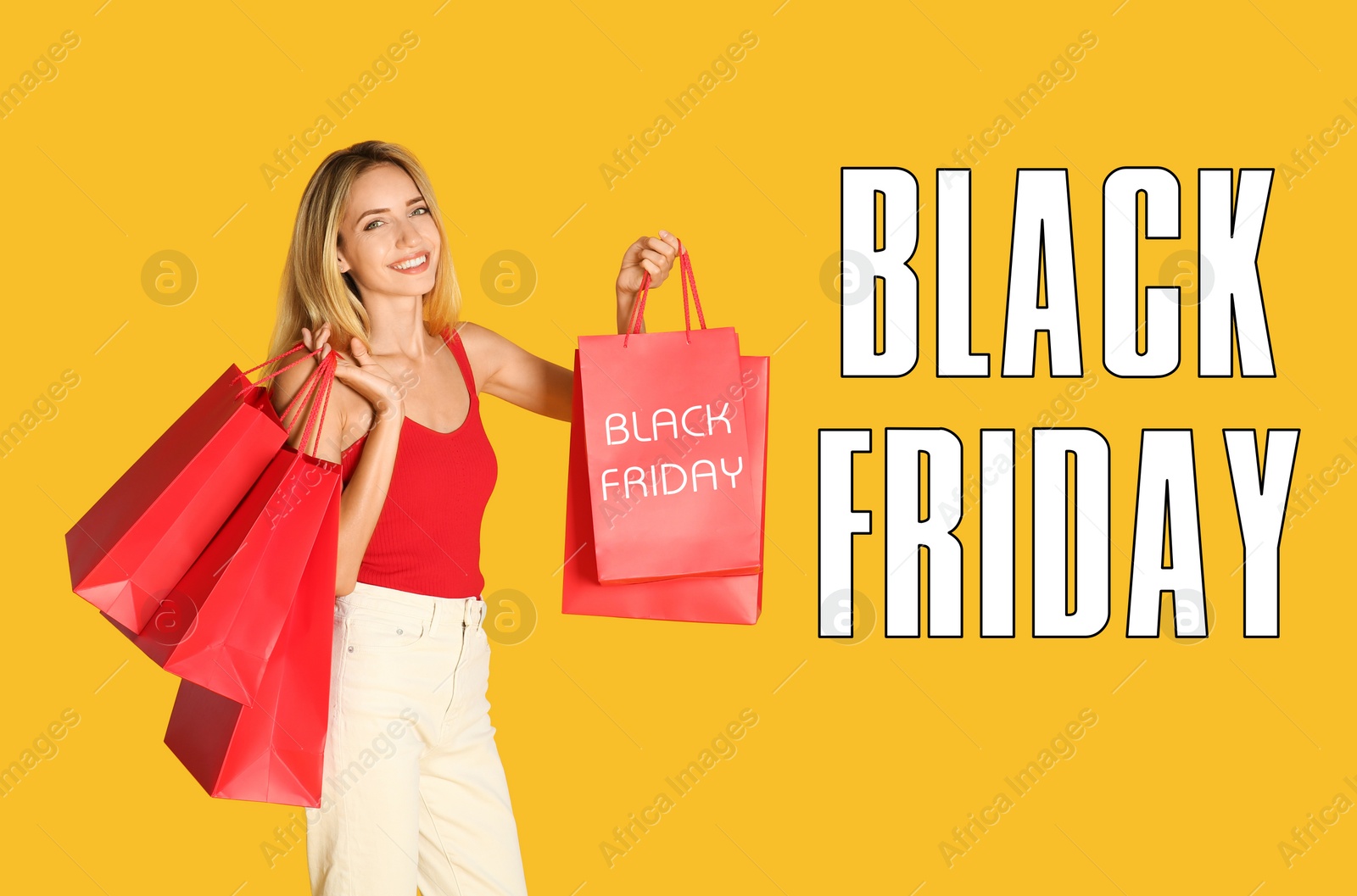 Image of Black Friday sale. Happy young woman with shopping bags on yellow background