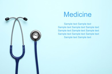 Image of Stethoscope on light blue background, top view. Space for text
