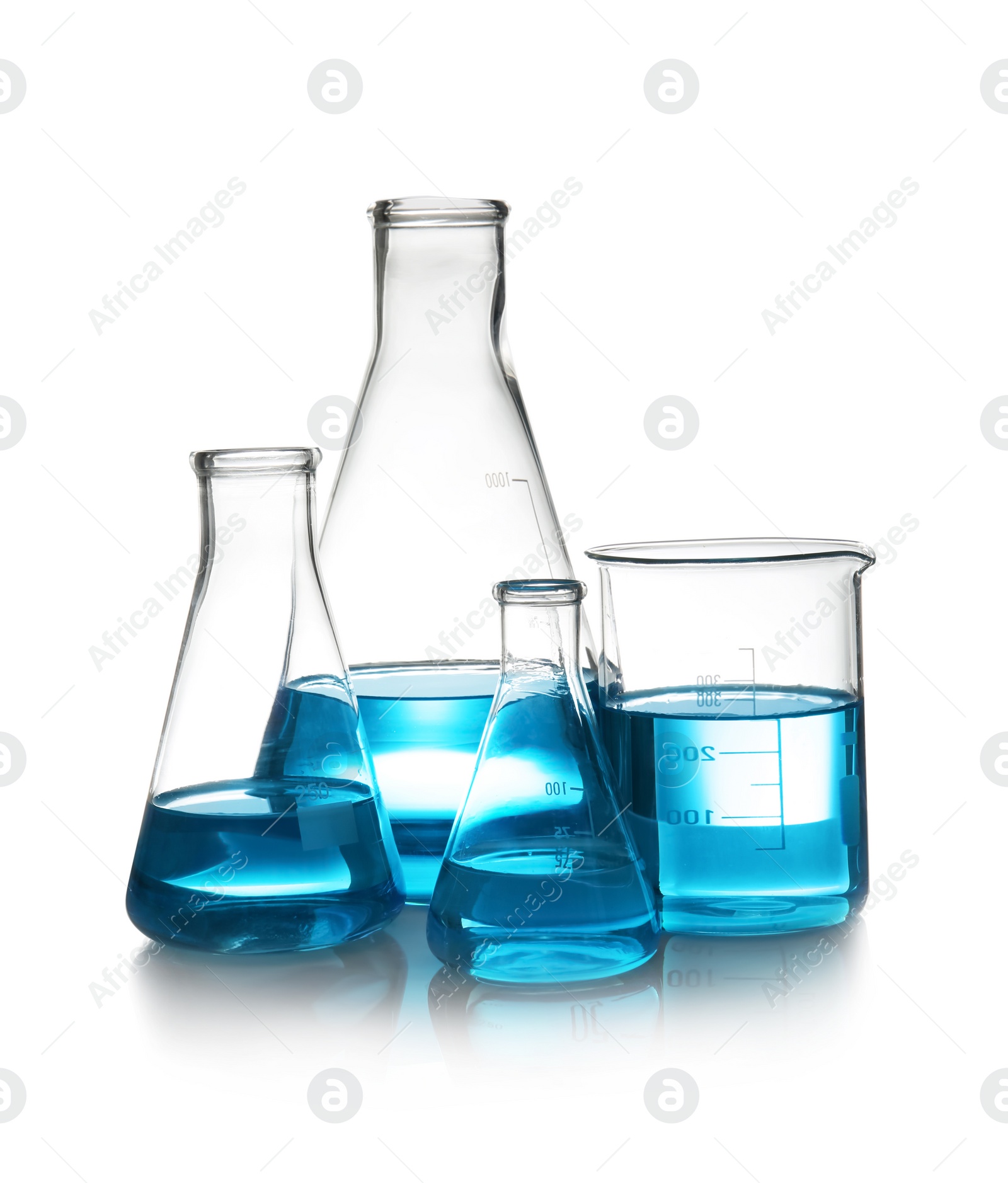 Photo of Laboratory glassware with liquid on table against white background. Chemical analysis