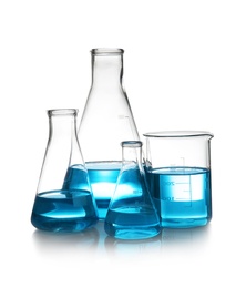 Photo of Laboratory glassware with liquid on table against white background. Chemical analysis