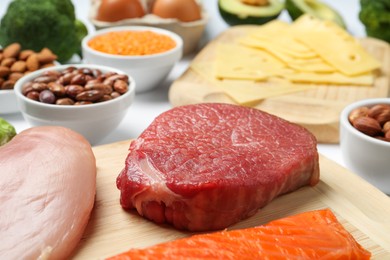 Photo of Fresh meat and other products on table, closeup. Sources of essential amino acids