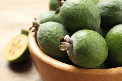 Fresh green feijoa fruits on light table, closeup. Space for text