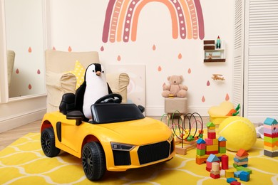 Photo of Child's electric car and other toys in playroom