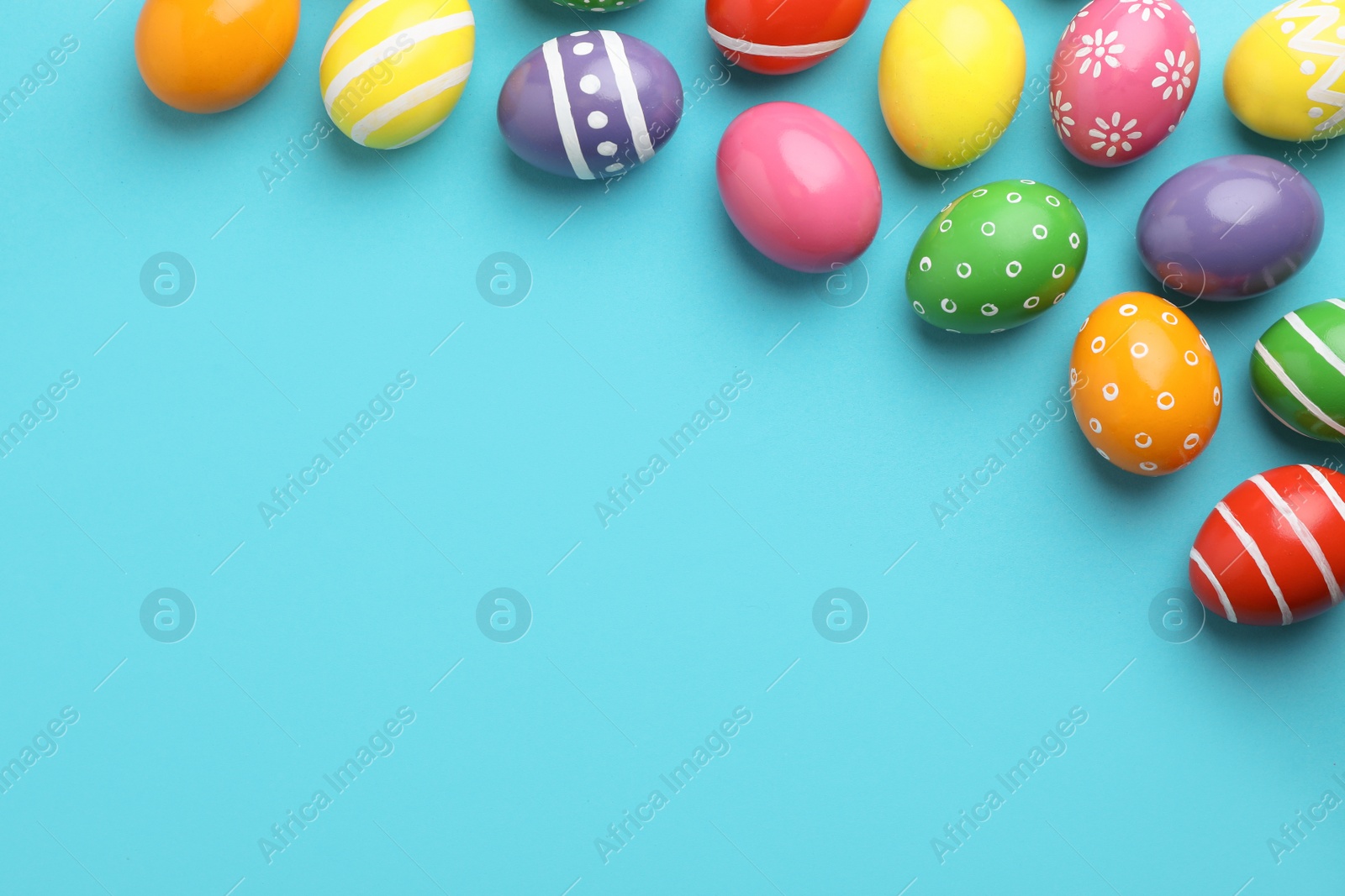 Photo of Decorated Easter eggs and space for text on color background, top view