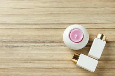 Photo of Flat lay composition with cosmetic products on wooden table, space for text. Spa therapy