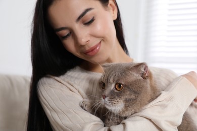 Photo of Woman with her adorable cat at home