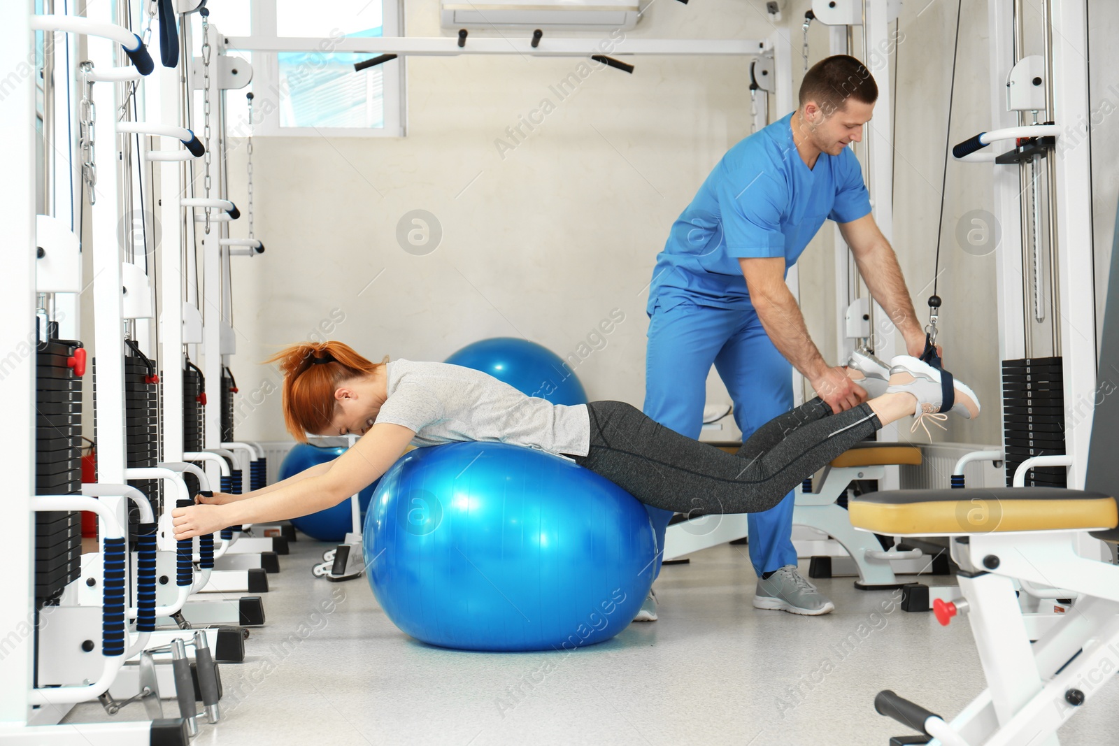 Photo of Patient exercising under physiotherapist supervision in rehabilitation center