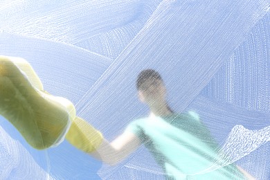 Photo of Woman cleaning glass with sponge on sunny day