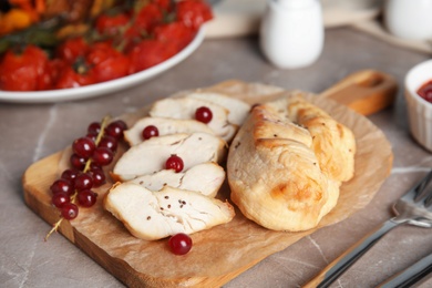 Photo of Tasty cooked chicken fillet served on grey table. Healthy meals from air fryer