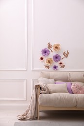 Photo of Stylish living room interior with floral decor and comfortable sofa