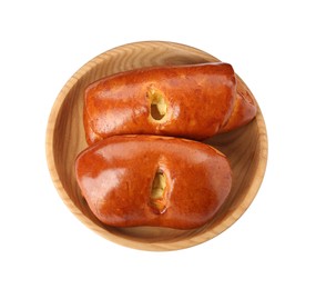 Photo of Wooden bowl with delicious baked patties on white background, top view