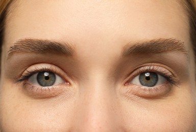 Photo of Beautiful woman with grey eyes, closeup view