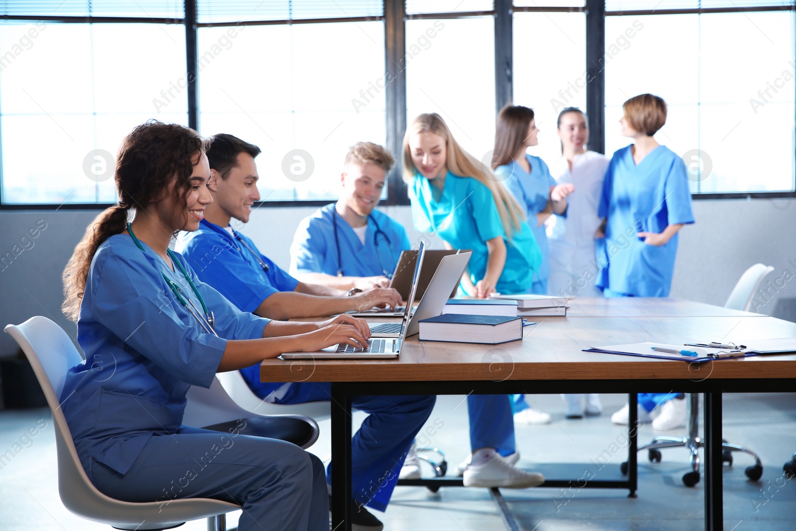 Photo of Group of smart medical students with gadgets in college