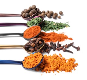 Photo of Metal spoons with different spices on white background