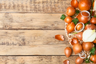 Photo of Flat lay composition with fresh ripe onions on wooden table