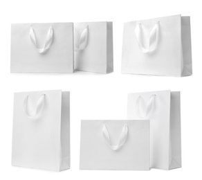 Image of Set with paper shopping bags on white background