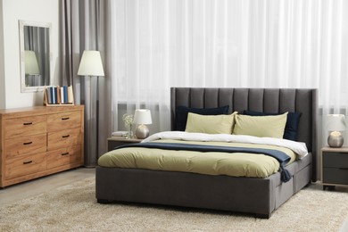 Photo of Stylish bedroom interior with large comfortable bed