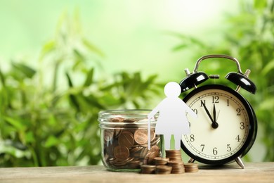 Image of Pension concept. Elderly woman illustration, coins and alarm clock on wooden table. Space for text