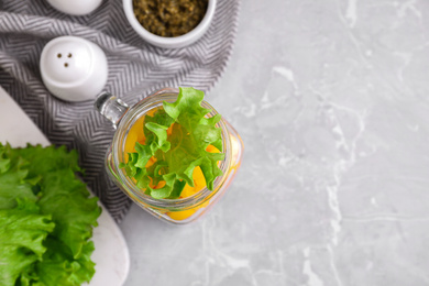 Photo of Healthy salad in glass jar on marble table, flat lay. Space for text