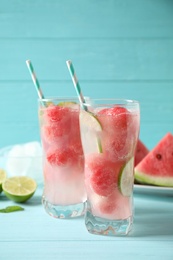 Photo of Delicious refreshing watermelon drink on blue wooden table, above view