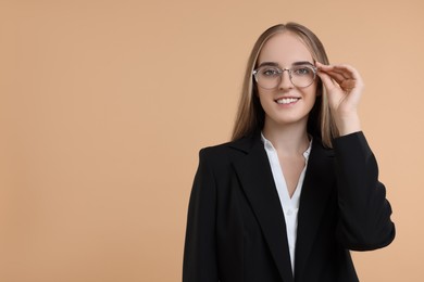 Photo of Portrait of happy young secretary on beige background, space for text