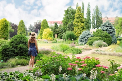 Photo of Young woman in beautiful garden on sunny day