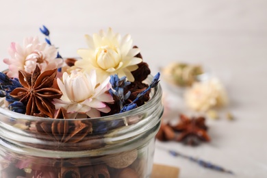 Photo of Aroma potpourri with different spices in jar, closeup view. Space for text