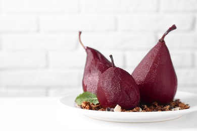 Photo of Tasty red wine poached pears with muesli on white table, closeup. Space for text