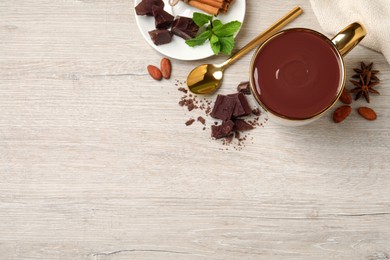 Photo of Flat lay composition with yummy hot chocolate on white wooden table, space for text