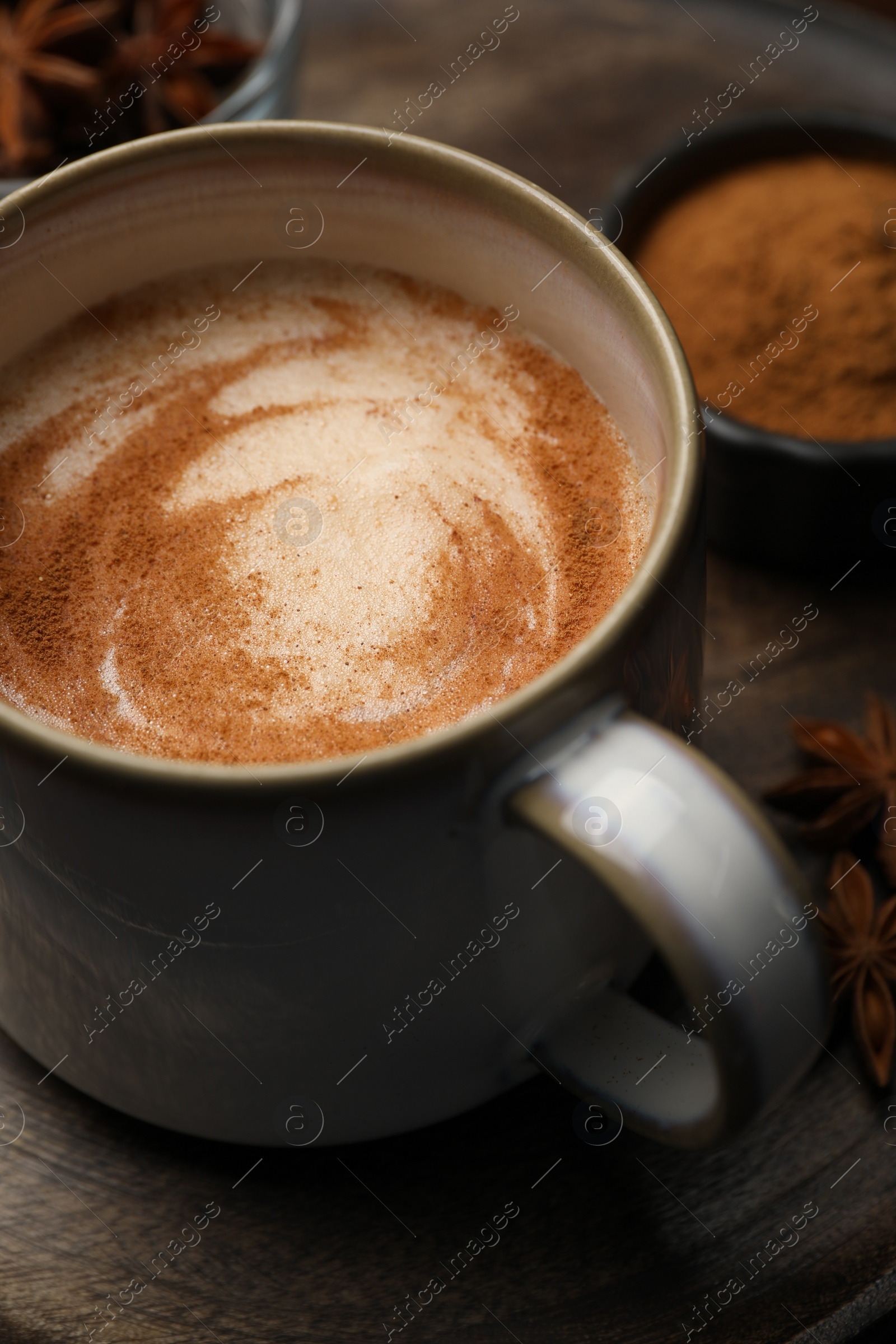 Photo of Cup of delicious eggnog on wooden table