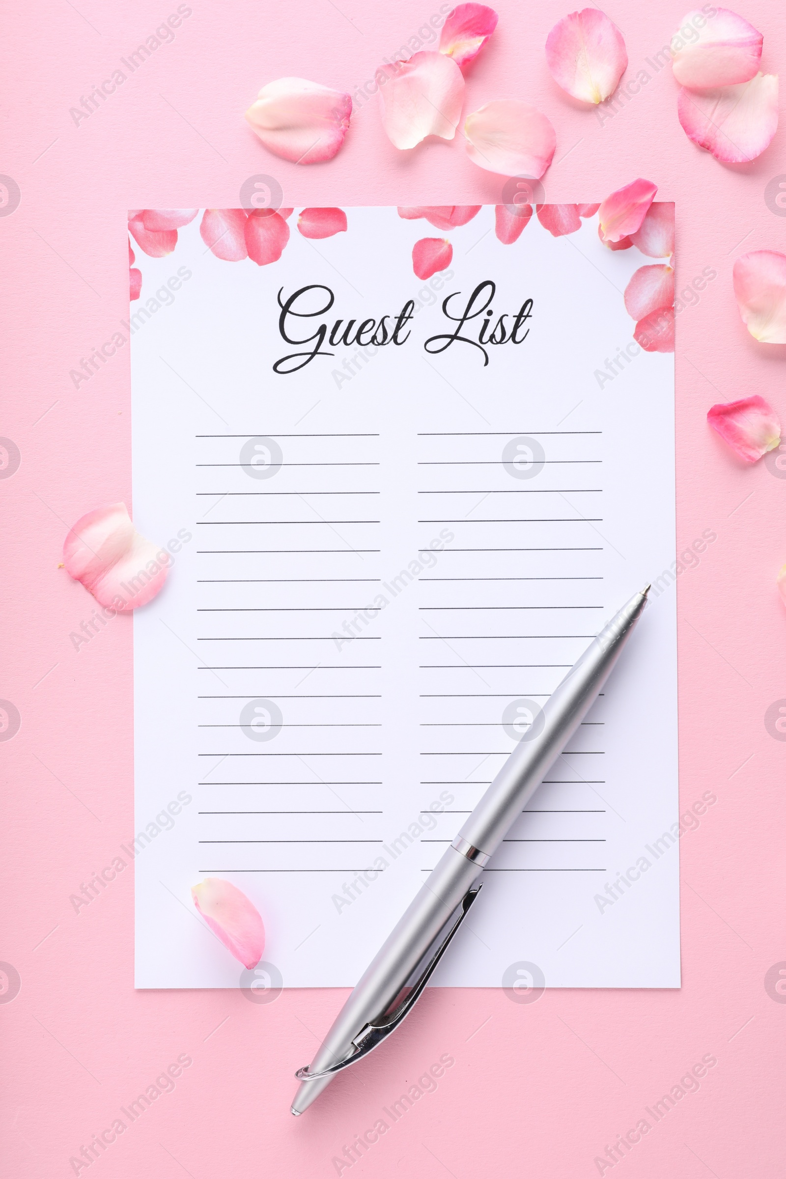 Photo of Guest list, pen and petals on pink background, flat lay. Space for text