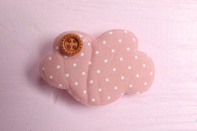 Cute hair clip on pink wooden table, top view