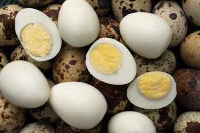 Photo of Heap of peeled and unpeeled hard boiled quail eggs as background, top view