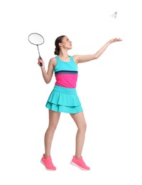 Young woman playing badminton with racket on white background