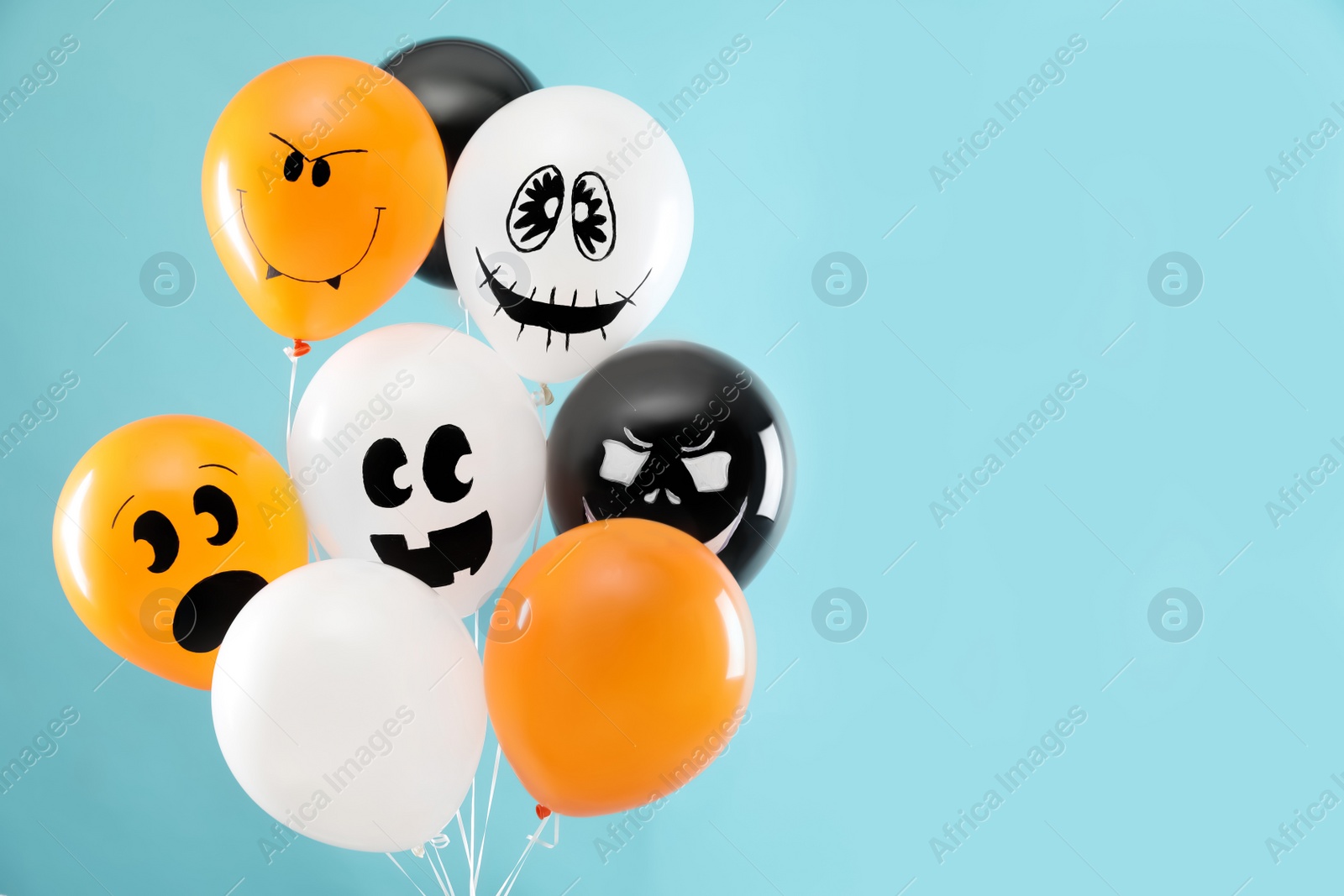 Photo of Color balloons for Halloween party on blue background, space for text