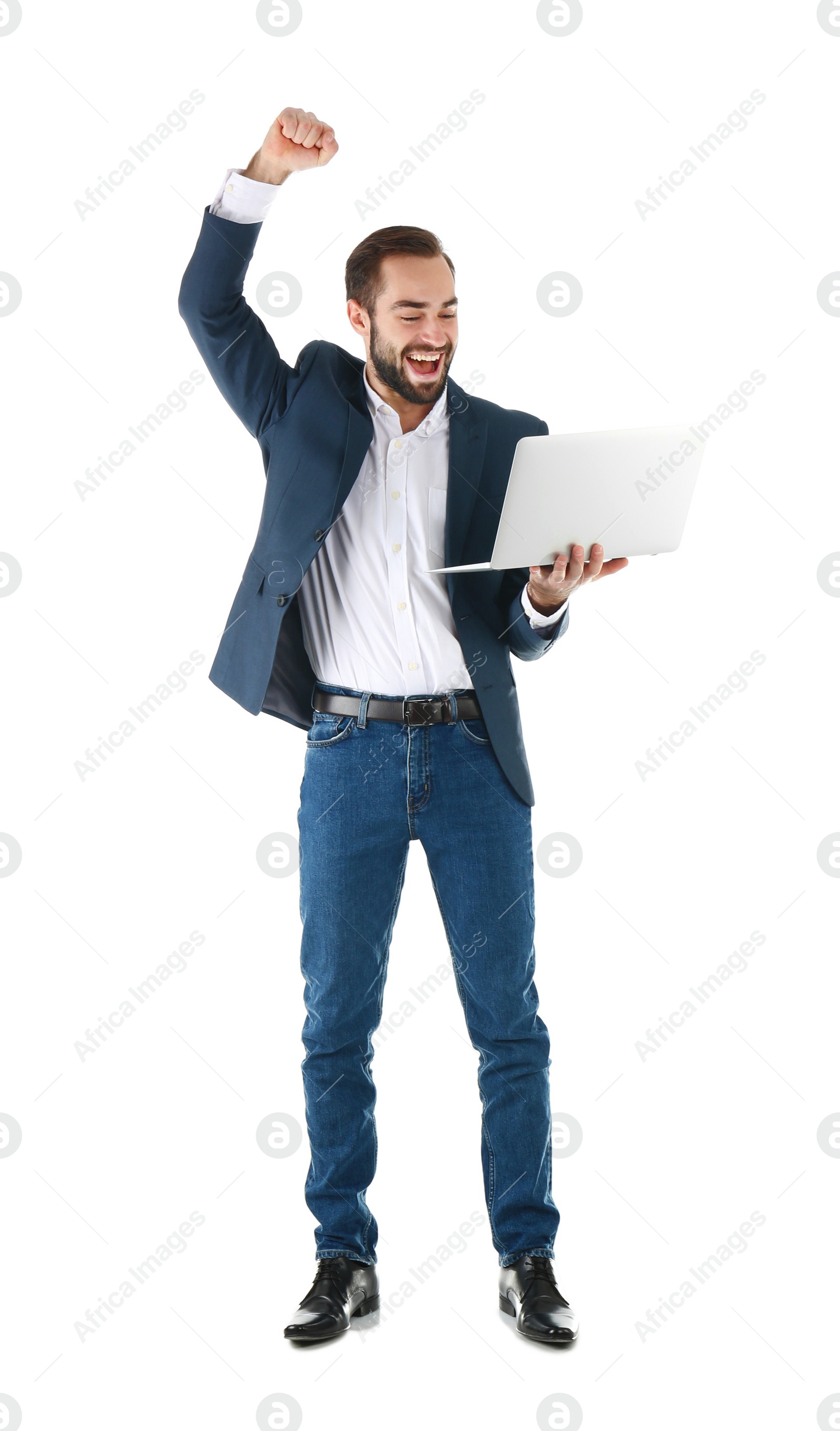 Photo of Emotional businessman in office wear with laptop celebrating victory on white background