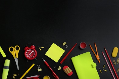 Photo of Different bright school stationery on black background, flat lay. Space for text