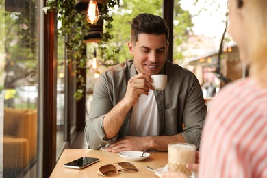 Lovely couple spending time at cafe in morning